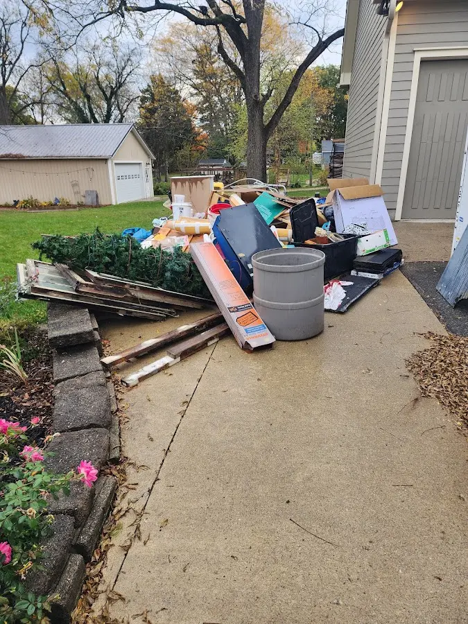 Dumpster being loaded with debris for Estate Cleanout Dumpster Rental in North Hudson